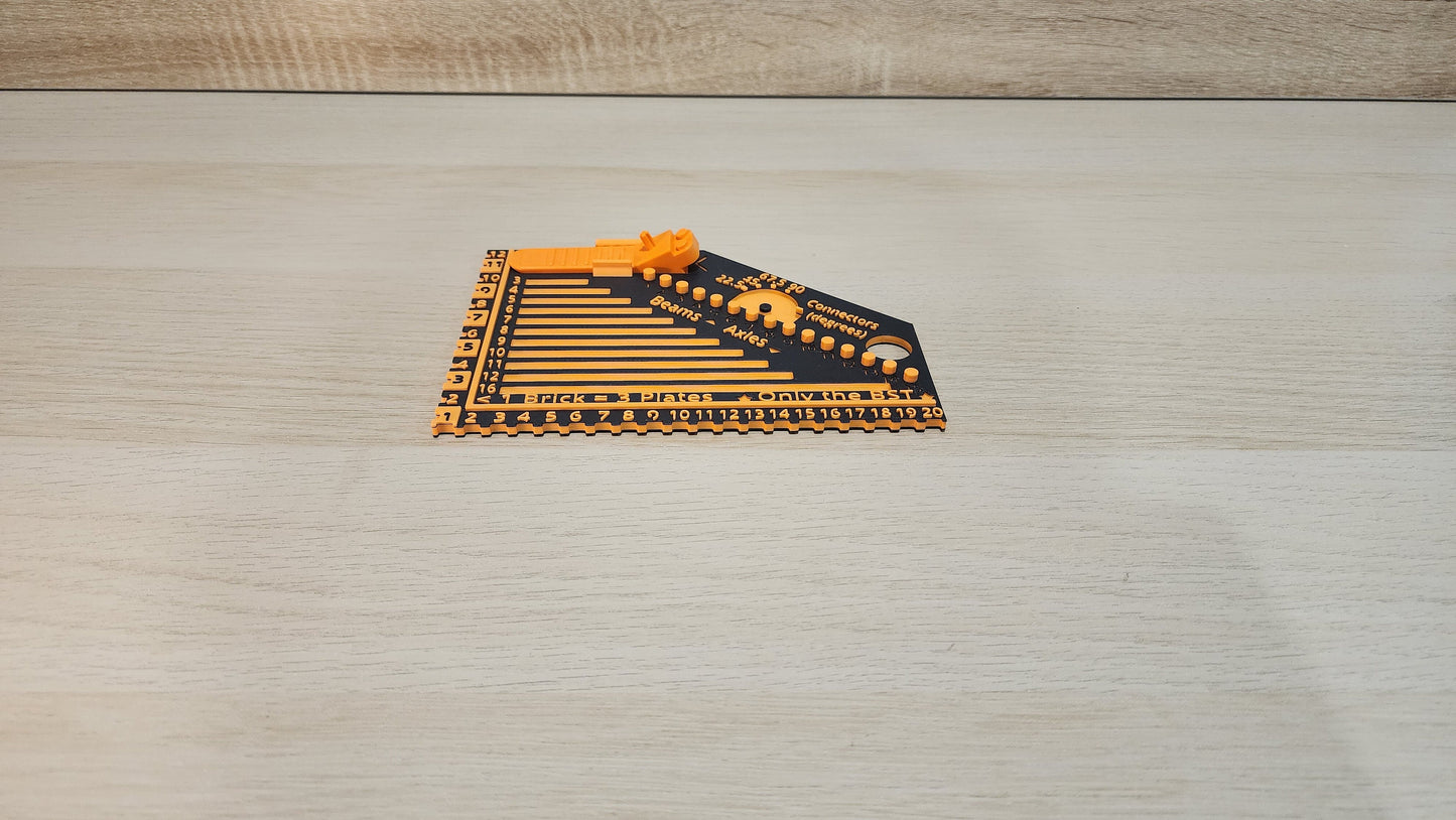 Black and orange brick ruler with a brick separator attached showing the side view.