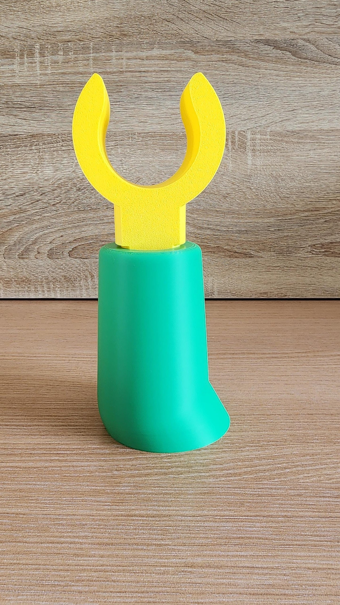 Green Minifig-Inspired Headphone Holder on wooden surface