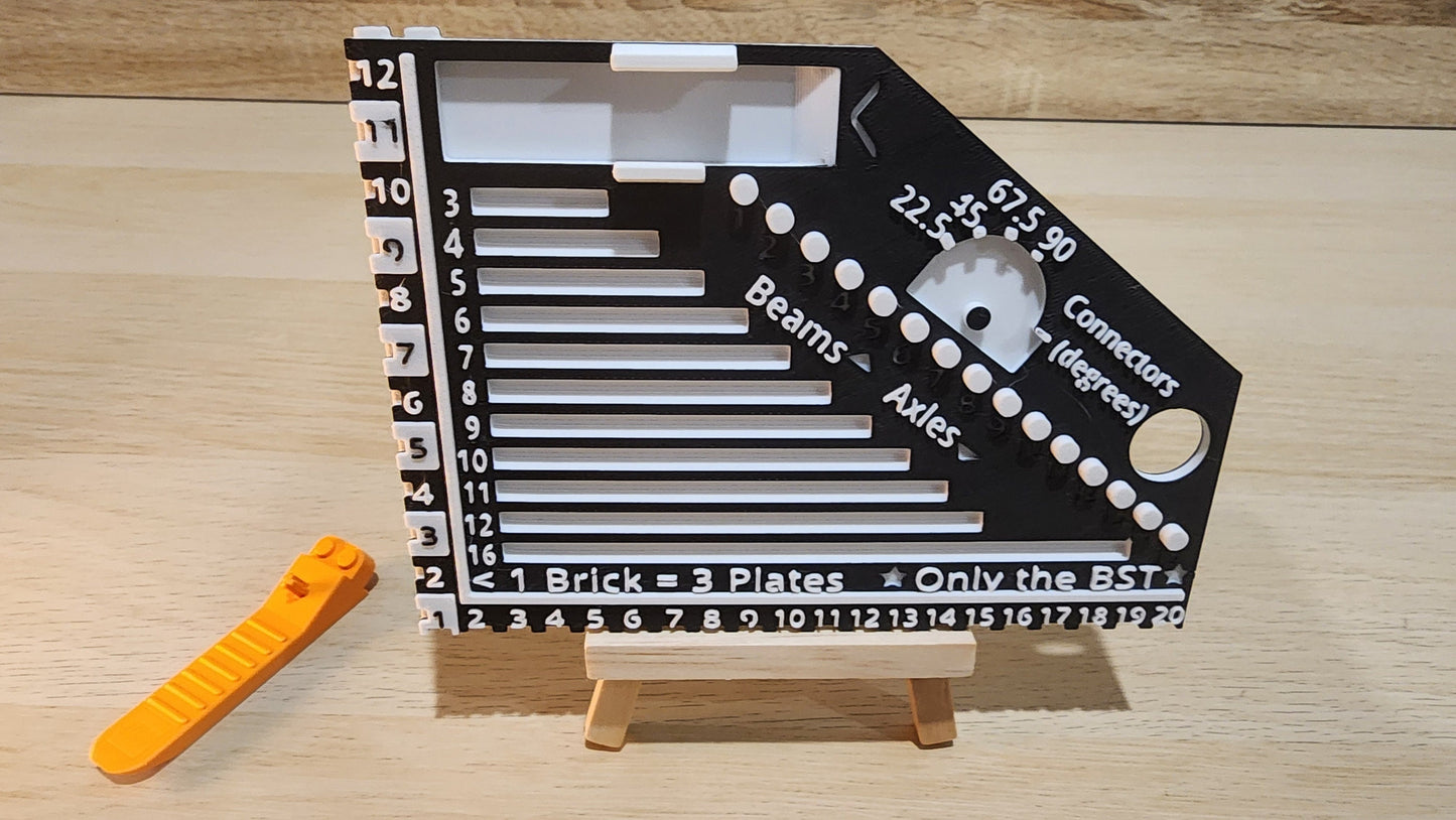 Black and white brick ruler with a brick separator next to the ruler.