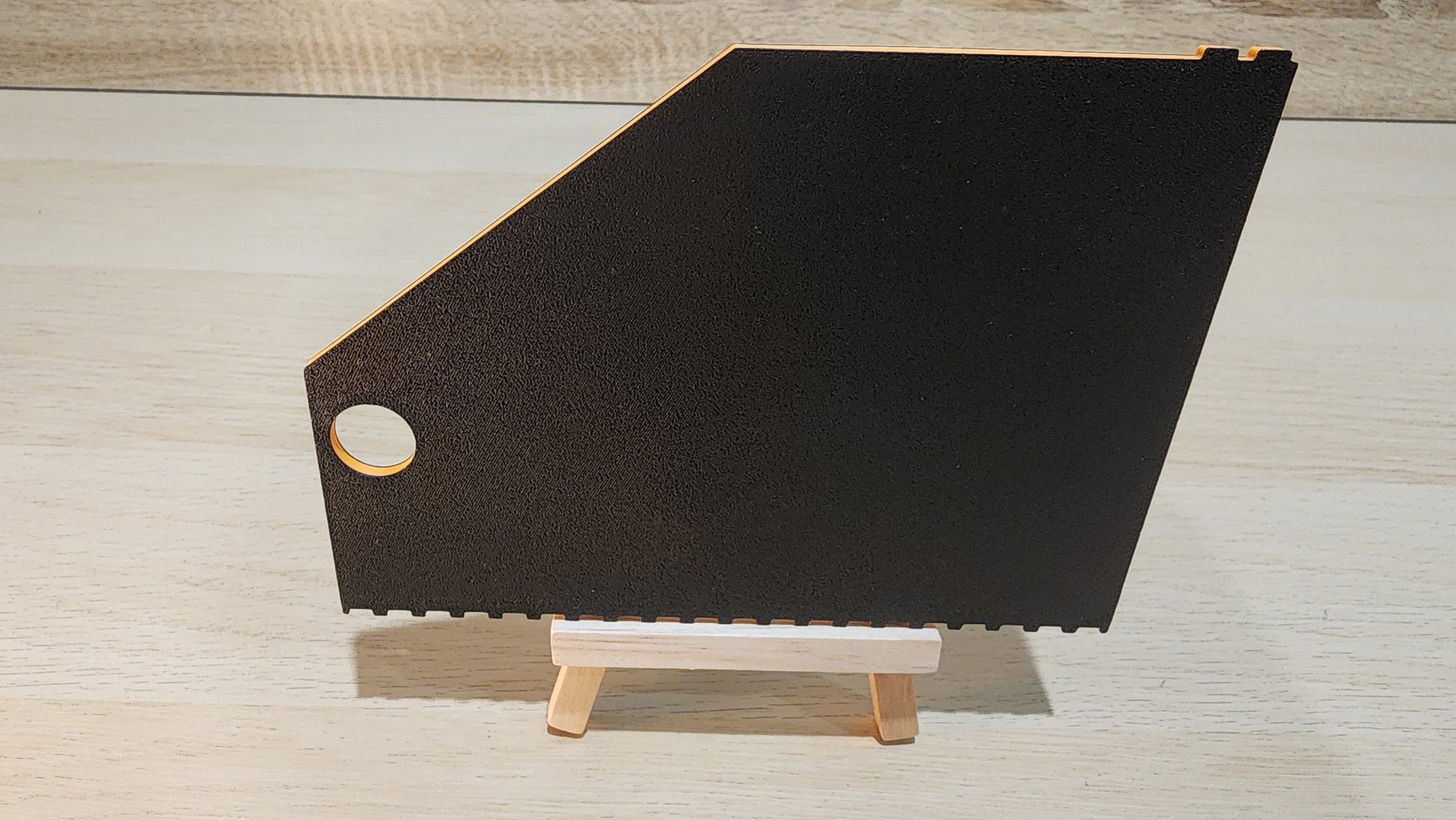 Black and orrange brick ruler showing the back view.