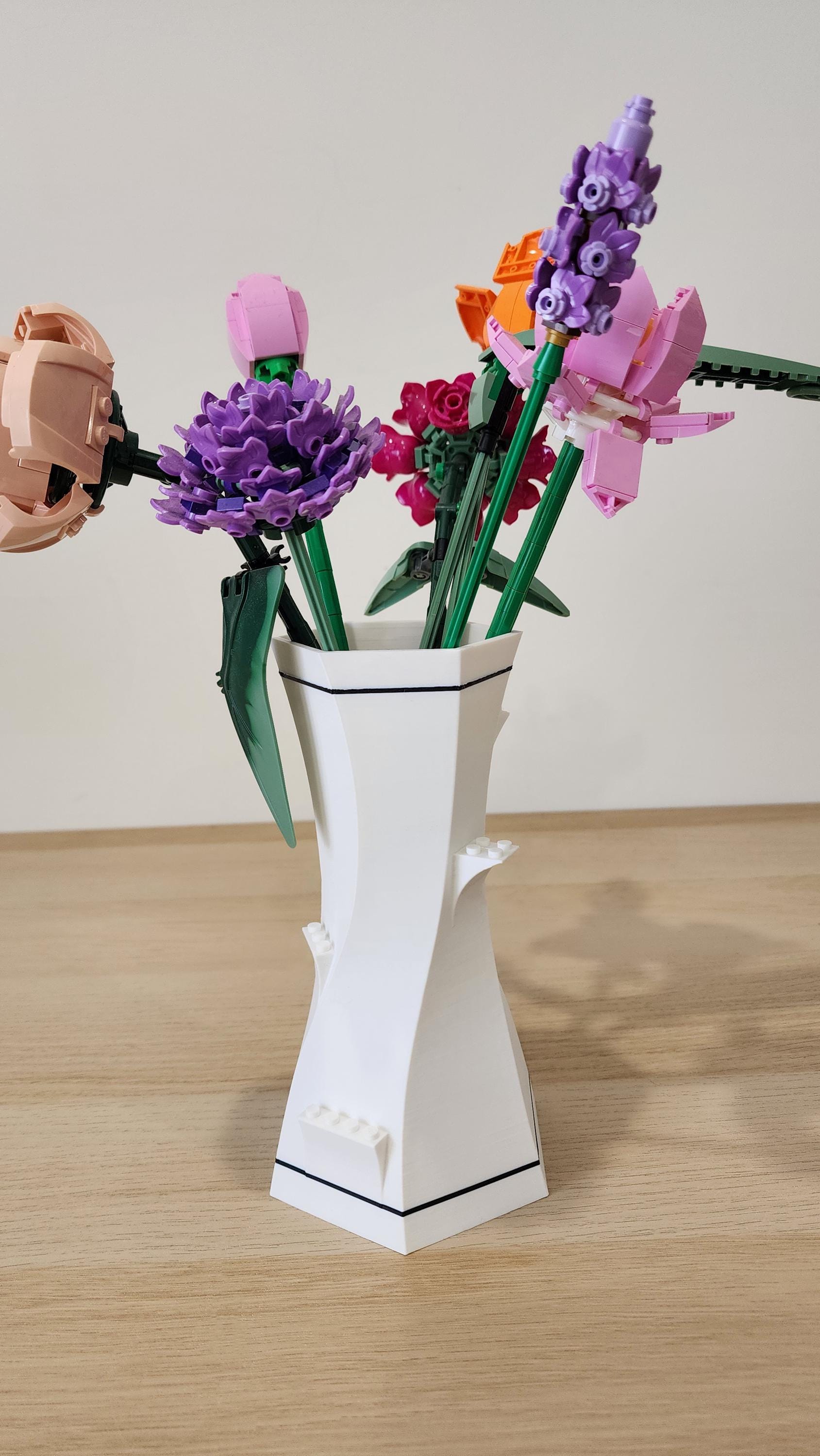 White and black LEGO-Compatible Vase with LEGO flowers and green LEGO stems