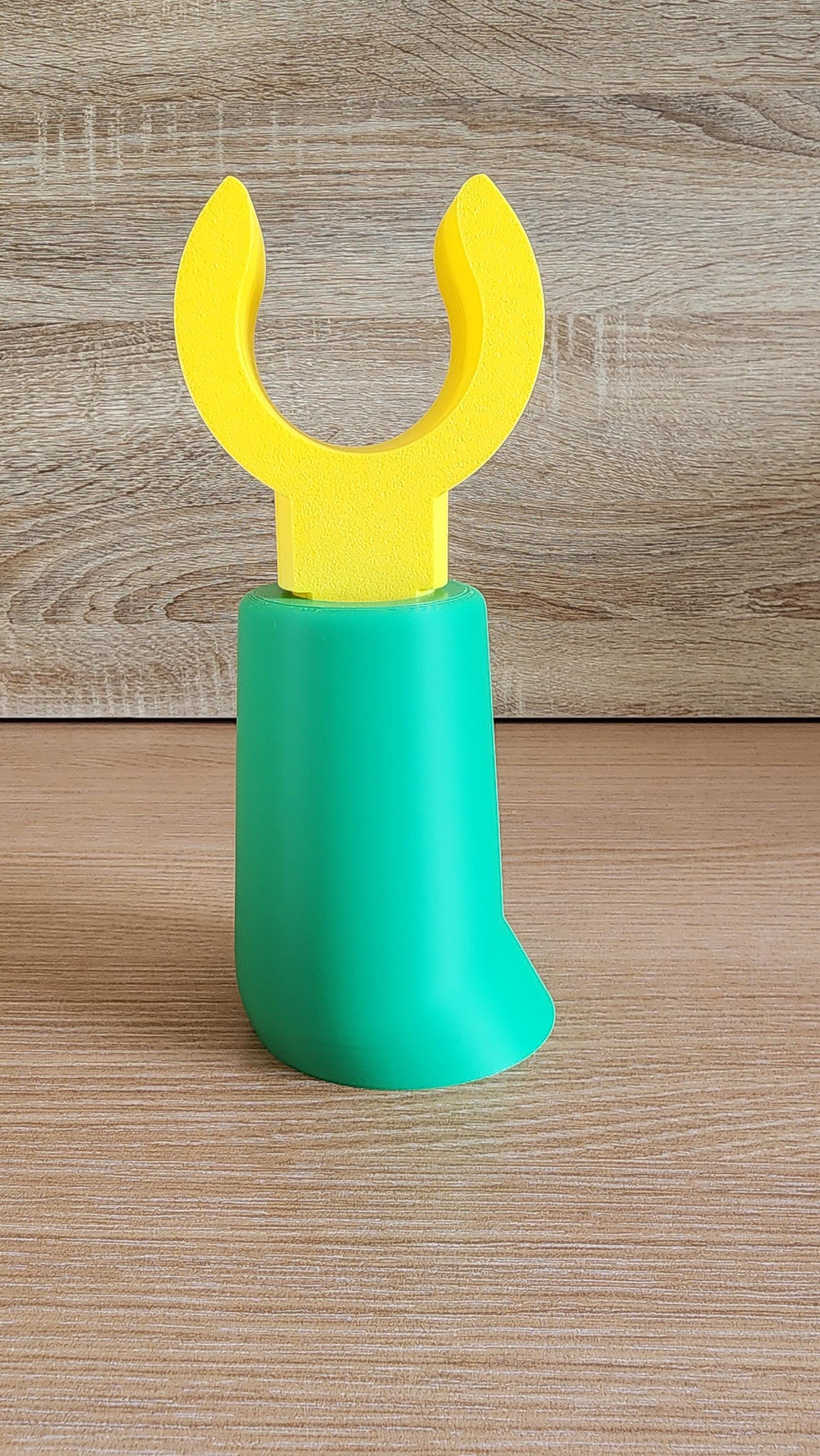 Green Minifig-Inspired Headphone Holder on wooden surface