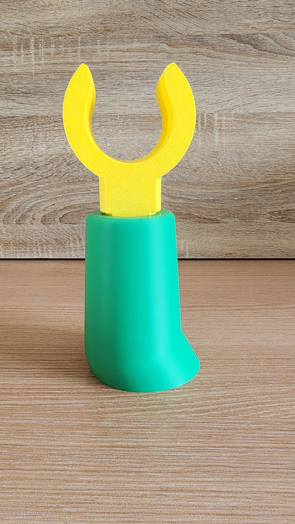 Green Minifig-Inspired Headphone Holder on wooden surface