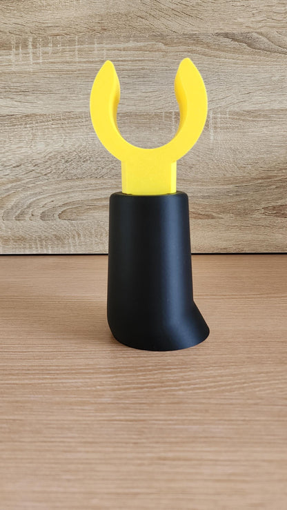 Black Minifig-Inspired Headphone Holder with yellow claw hand on wood background